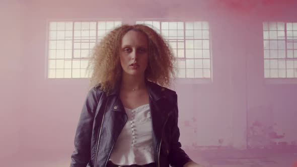 Fashionable young woman in an abandoned warehouse