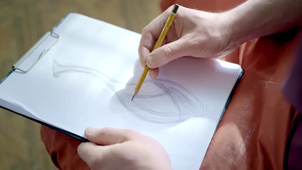 The Artist Drawing a Flat Line with a Black Pencil. Artists Hands Drawing Wooden Pencil Writes Line