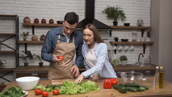 Cooking Salad at Home Young Woman and Man Preparing for Cooking Salad Checking Ingredients for