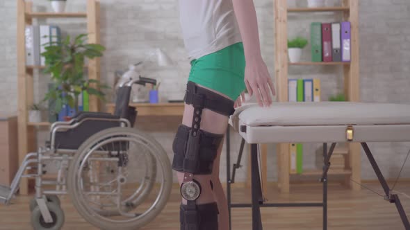Young Woman Walking Orthosis Knee Brace After Injury