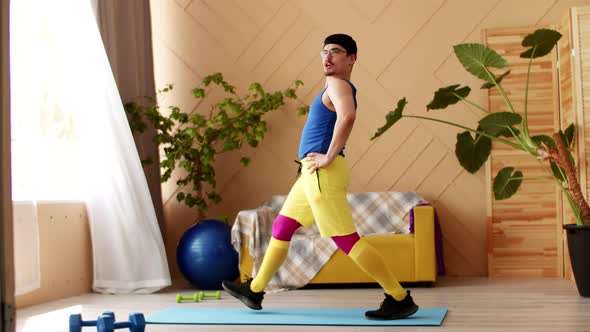 Expressive Funny Overweight Young Caucasian Man in Sportswear Doing Fitness Sports and Watching TV