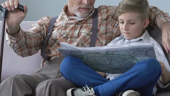 School Boy Learning World Map With Grandfather Help, Pensioner Sharing Knowledge