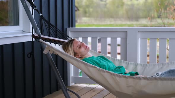 woman resting in a hammock on the terrace