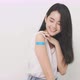 Smiling Asian Woman Shows Bandage On Arm. - VideoHive Item for Sale