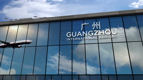 Airplane landing at Guangzhou China airport mirrored in terminal