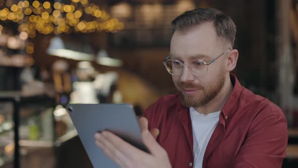 Programmer Typing at Tablet While Working at Cafe