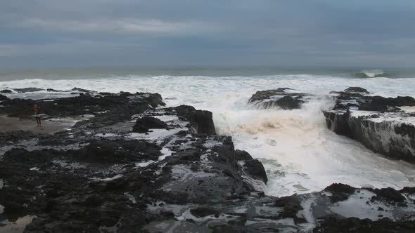 Waves crashing on rocky kicking up mist