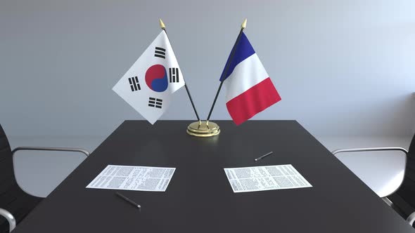 Flags of South Korea and France on the Table