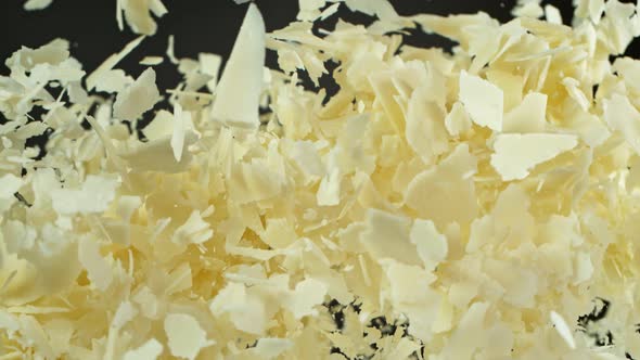 Super Slow Motion Shot of Flying Parmesan Shavings on Black Background at 1000 Fps