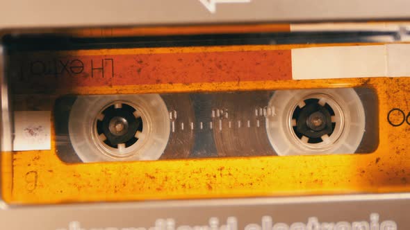 Vintage Yellow Audio Cassette in the Tape Recorder Playing and Rotates