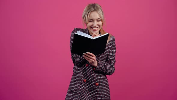 A Very Cheerful Student She Holds a Notebook in Her Hand and Notes with a Smile and Enjoys Success