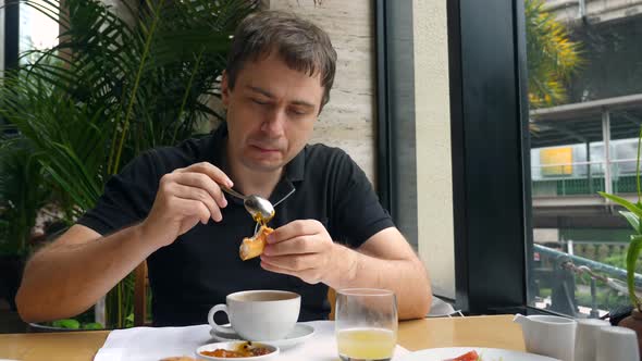 Male Enjoy Eating Morning Food in Restaurant Drinking Hot Cappuccino Coffee