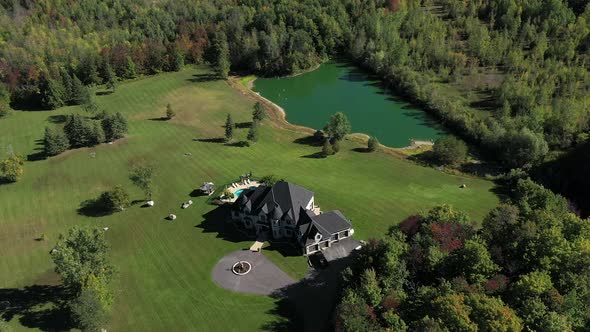 wealthy home oasis aerial surrounded by forest