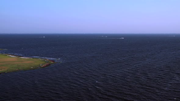 a slow drone aerial pan left over the waters at East Islip Marina & Park looking at the green & yell