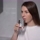 A Young Woman is Holding a Glass of Clean Water - VideoHive Item for Sale