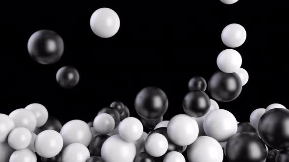 Black and White Balls Fall Into a Pool or Screen on a Black Background