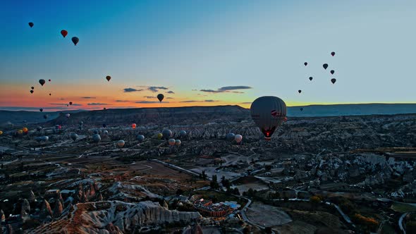 Hotair Balloons Flying Over the Mountain Landsape of CappadociaTurkey