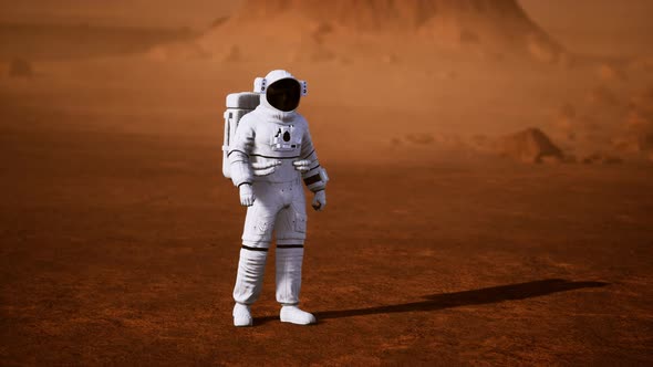 Astronaut on Mars Surface. Red Planet Covered in Gas and Rock