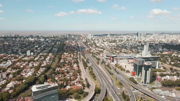 Aerial dolly right shot of General Paz Avenue, Buenos Aires city and La plata river