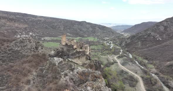 Aerial view of Drisi Castle situated on a mountain above the Tedzami River gorge. Georgia 2022