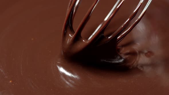 Chef Stirring Mixing Melted Liquid Premium Dark Chocolate with Whisk Preparation of Handmade Candies