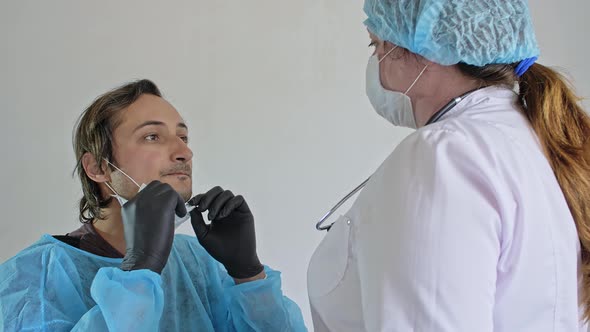 Medic Takes a Patient Oral Swab in the Room