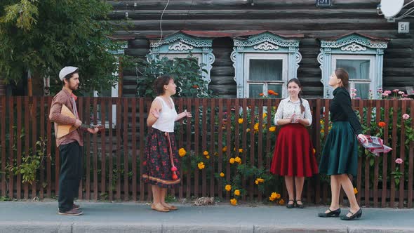 Young Women Dancing on the Street in the Village By the Music