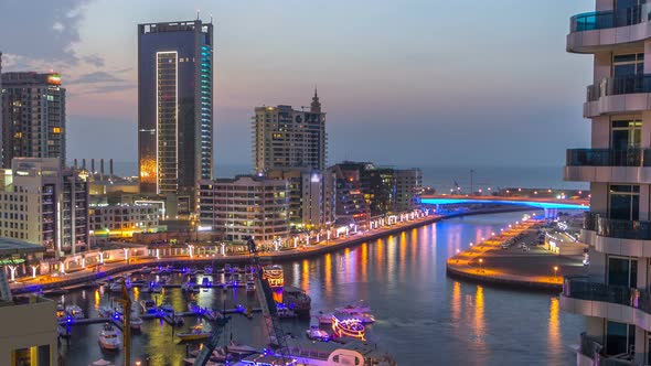 An Aerial View of Dubai Marina Towers in Dubai Day to Night Timelapse