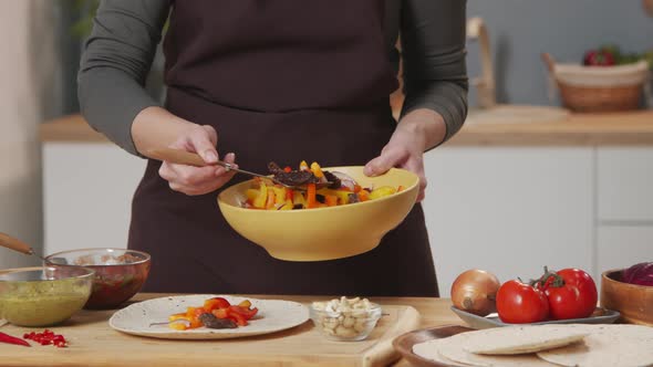 Woman Preparing Tacos at Kitchen Table