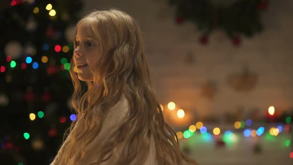 Little Girl Dancing Near Beautiful Christmas Decorations, Waiting for Holiday