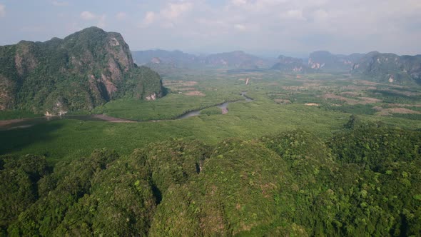 drone flying high over Ao Thalane mountains overlooking the river and mangroves on a sunny day in Kr