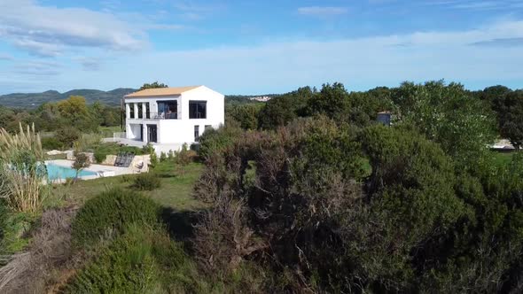 Stunning aerial drone flight slowly sinking down drone shot of a villa house with pool on canyon cli