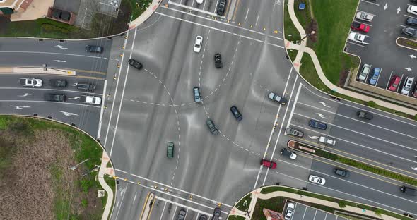 Confusing multilane traffic intersection with cars crossing lanes. Top down birds eye aerial. Danger