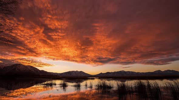 Time lapse of colorful sunrise over Utah Lake as sky glows