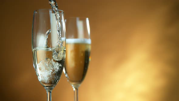 Super Slow Motion Shot of Pouring Champagne on Golden Luxury Background at 1000Fps