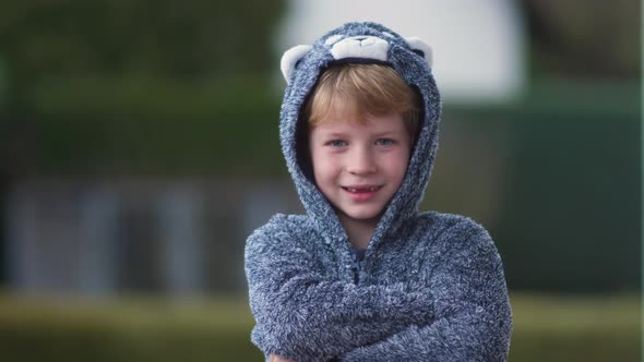 Funny young boy in bear suit has fun on camera alt