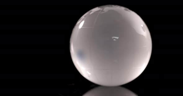 Transparent Glass Globe is Spinning on Black Background