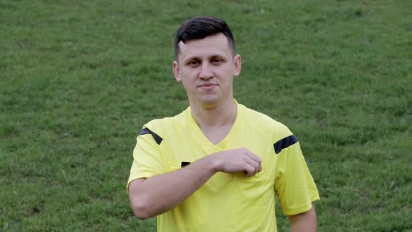 Referee showing a red card to a displeased football or soccer player while gaming.