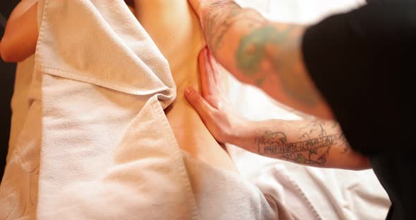 Woman Receiving Back Massage in Spa