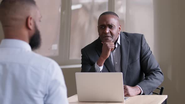 Mature Businessman African Boss Middle Age 50s Leader Sitting at Table with Laptop Talking to