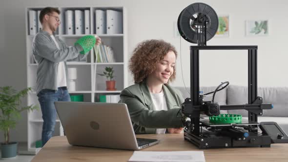 Creative and Design Portrait of Young Woman and Man Printing Prototype of Ceiling Lamp Model for