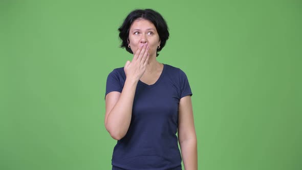 Beautiful Woman Covering Mouth While Looking Guilty