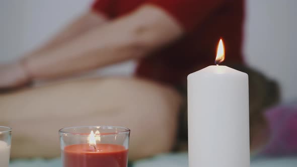 Massage Therapist Works with Woman in Professional Clinic