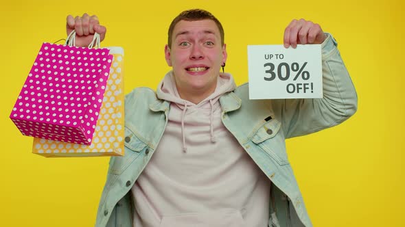 Cheerful Teen Man Showing Shopping Bags and Up To 30 Percent Off Inscriptions Banner Black Friday