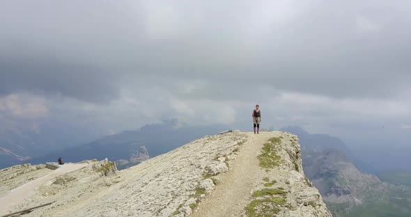 Aerial drone view of a woman hiking in the mountains