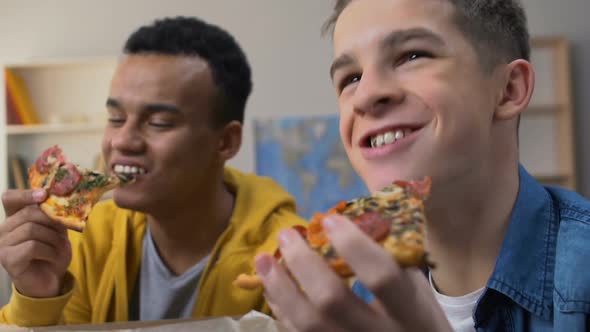 Two Friends Laughing, Watching Sitcom Comedy Series on Tv While Eating Pizza