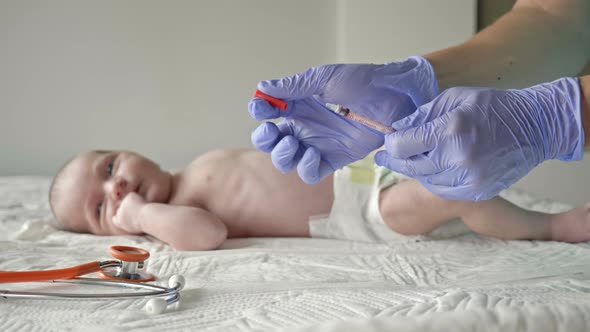 Pediatrician Vaccinates the Newborn in the Clinic