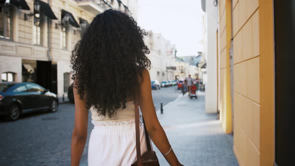 Darkskinned Woman in White Outfit and Sunglasses