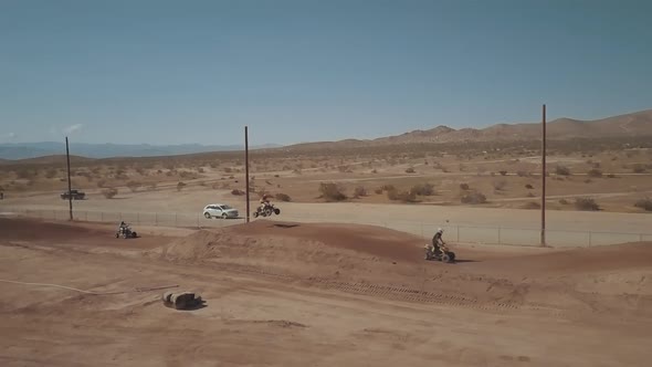 ATV racing on a dirt track in California City on a spring day, AERIAL