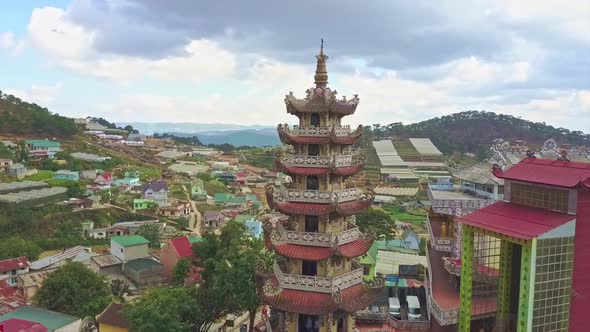 Drone Rotates Around Buddhist Temple Pagoda Against Sky